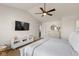 Bright main bedroom featuring a ceiling fan, TV, a dresser, and crisp neutral décor at 4801 Copper Grove Dr, Indianapolis, IN 46237
