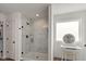 Elegant bathroom with a glass enclosed shower, a vanity, and a separate dressing table at 5387 Citadel Dr, Noblesville, IN 46062