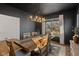 Stylish dining room with dark walls, a wooden table, and natural light streaming through the window at 5387 Citadel Dr, Noblesville, IN 46062
