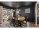 Elegant dining room features dark walls, a modern chandelier, and a wooden table with seating for six at 5387 Citadel Dr, Noblesville, IN 46062