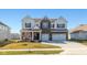 Beautiful two-story home with brick and siding, a three-car garage, and a well-manicured lawn at 5387 Citadel Dr, Noblesville, IN 46062