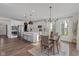 Spacious kitchen features an island with seating, stainless steel appliances, and flows into a dining area at 5387 Citadel Dr, Noblesville, IN 46062