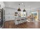 Modern kitchen boasts an island with seating, stainless steel appliances, and a connected dining area at 5387 Citadel Dr, Noblesville, IN 46062