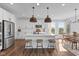 Bright kitchen features a large island with pendant lights, modern appliances, and wood-look flooring at 5387 Citadel Dr, Noblesville, IN 46062