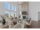 Spacious living room with soaring ceilings, a stone fireplace, and large windows at 5387 Citadel Dr, Noblesville, IN 46062