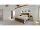 Bright main bedroom featuring wood beams, a ceiling fan, and an ensuite bathroom at 5387 Citadel Dr, Noblesville, IN 46062