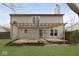 Backyard with wooden pergola covered patio and freshly cut green grass at 5869 Jamestown Square Ln, Indianapolis, IN 46234