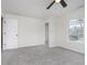 Neutral bedroom featuring a ceiling fan, carpeted floors, and a bright window at 5869 Jamestown Square Ln, Indianapolis, IN 46234