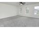 Expansive primary bedroom with ample light, neutral paint, and comfortable carpeting at 5869 Jamestown Square Ln, Indianapolis, IN 46234