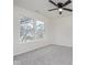 Neutral bedroom featuring a ceiling fan, carpeted floors, and a bright window at 5869 Jamestown Square Ln, Indianapolis, IN 46234