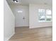 Clean foyer with hard surface floors, white door with glass, and view of stairs at 5869 Jamestown Square Ln, Indianapolis, IN 46234