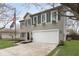 Charming two-story home with a two-car garage and flower boxes under the windows at 5869 Jamestown Square Ln, Indianapolis, IN 46234