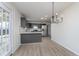 Bright kitchen with modern gray cabinets, stainless steel appliances, and stunning light fixture at 5869 Jamestown Square Ln, Indianapolis, IN 46234