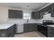 Updated kitchen with gray cabinets, stainless steel appliances, and white stone countertops at 5869 Jamestown Square Ln, Indianapolis, IN 46234