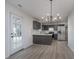 Modern kitchen with dark cabinetry, stainless appliances, and hardwood floors, open to dining area at 5869 Jamestown Square Ln, Indianapolis, IN 46234