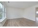 Bright, open living room with wood-look floors and a large window at 5869 Jamestown Square Ln, Indianapolis, IN 46234