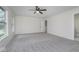 Spacious primary bedroom with ceiling fan, neutral tones, and large window at 5869 Jamestown Square Ln, Indianapolis, IN 46234