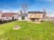 Lush backyard featuring a patio area, plenty of green space, and a fire pit at 5927 Timber Lake Blvd, Indianapolis, IN 46237