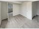 Neutral-toned carpeted bedroom featuring an open doorway, window, and a closet for ample storage and natural light at 5927 Timber Lake Blvd, Indianapolis, IN 46237