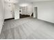 Spacious living room featuring a combination of carpet and hardwood flooring leading to the kitchen at 5927 Timber Lake Blvd, Indianapolis, IN 46237