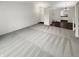 Bright living room featuring a combination of carpet and hardwood flooring leading to the kitchen at 5927 Timber Lake Blvd, Indianapolis, IN 46237