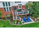 Inviting backyard featuring a spacious deck with outdoor seating and a beautifully landscaped yard with lush greenery at 6110 Tanana Dr, Carmel, IN 46033