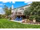 Exterior shot of a home with a backyard featuring a deck, patio, and lush lawn at 6110 Tanana Dr, Carmel, IN 46033