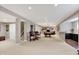 Spacious basement with a neutral color scheme and multiple entertainment zones at 6110 Tanana Dr, Carmel, IN 46033