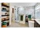 Bright bathroom featuring double sinks, a soaking tub, and a glass-enclosed shower at 6110 Tanana Dr, Carmel, IN 46033