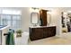 Primary bathroom features a soaking tub, dual sinks, dark wood cabinets and access to the closet at 6110 Tanana Dr, Carmel, IN 46033