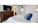 Bright bedroom featuring a tv over a wooden dresser and a connecting bathroom at 6110 Tanana Dr, Carmel, IN 46033