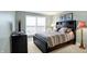 Bedroom featuring a black bed set, carpet, and large window to bring in natural light at 6110 Tanana Dr, Carmel, IN 46033