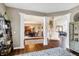 Inviting foyer showcasing hardwood floors, decorative columns, and staircase leading to the upper level at 6110 Tanana Dr, Carmel, IN 46033