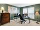 Spacious home office with a dark green color scheme, a world map, and a computer setup at 6110 Tanana Dr, Carmel, IN 46033