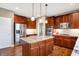 Modern kitchen with stainless steel appliances, a center island, and ample cabinet space at 6110 Tanana Dr, Carmel, IN 46033