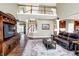 Bright living room with a high ceiling, a staircase and open access to a modern kitchen at 6110 Tanana Dr, Carmel, IN 46033