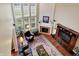 High-angle view of a living room featuring a soaring fireplace, large windows, and hardwood floors at 6110 Tanana Dr, Carmel, IN 46033