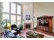 Cozy living room features a fireplace, high ceiling, and an entertainment center at 6110 Tanana Dr, Carmel, IN 46033