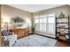 Cozy living room featuring a large window, decorative shelving, and a comfortable sitting area at 6110 Tanana Dr, Carmel, IN 46033