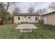 Backyard featuring a patio with a brick firepit and adjacent garage at 631 E 86Th St, Indianapolis, IN 46240