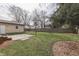 The large backyard showcasing the perfect space for outdoor enjoyment with grass and mature trees at 631 E 86Th St, Indianapolis, IN 46240