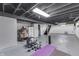 Spacious basement with painted walls, showcasing a workout space with yoga mat and weights at 631 E 86Th St, Indianapolis, IN 46240
