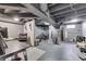 Finished basement area perfect for home office featuring painted concrete floors, an open ceiling, and bright lighting at 631 E 86Th St, Indianapolis, IN 46240