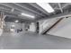 Spacious basement with gray painted walls, exposed ceiling, and ample room for storage and recreation at 631 E 86Th St, Indianapolis, IN 46240