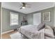 Well-lit bedroom with ample natural light, ceiling fan, and a bed with soft linens at 631 E 86Th St, Indianapolis, IN 46240