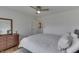 Bedroom with wooden dresser, paneled walls, and a comfortable bed with white linens at 631 E 86Th St, Indianapolis, IN 46240