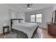 Cozy bedroom with neutral decor, ceiling fan, large windows, and patterned rug at 631 E 86Th St, Indianapolis, IN 46240