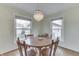 Bright dining room with a chandelier and views of the backyard at 631 E 86Th St, Indianapolis, IN 46240