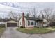 Exterior view of a charming home with a detached garage and well-maintained lawn at 631 E 86Th St, Indianapolis, IN 46240