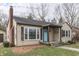 Classic home with brick chimney, large windows, and eye-catching turquoise front door at 631 E 86Th St, Indianapolis, IN 46240